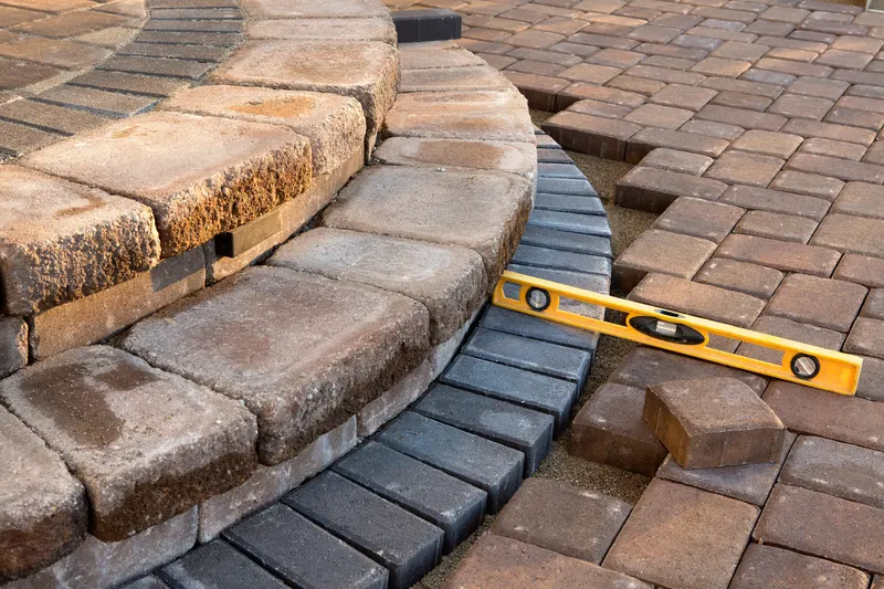 Block paving and brick edging being laid